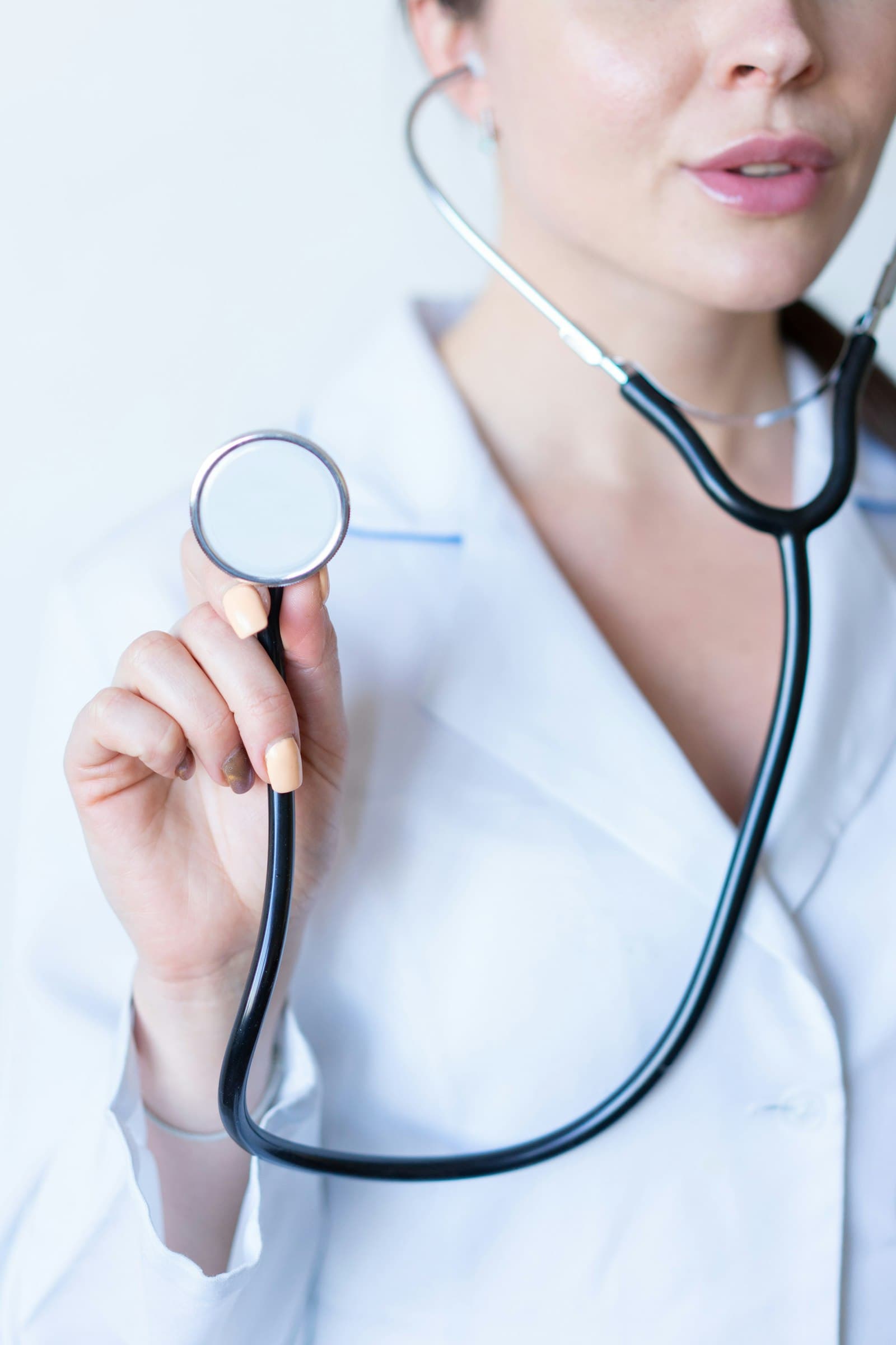 Physician using a digital tablet at the bedside while reviewing patient information