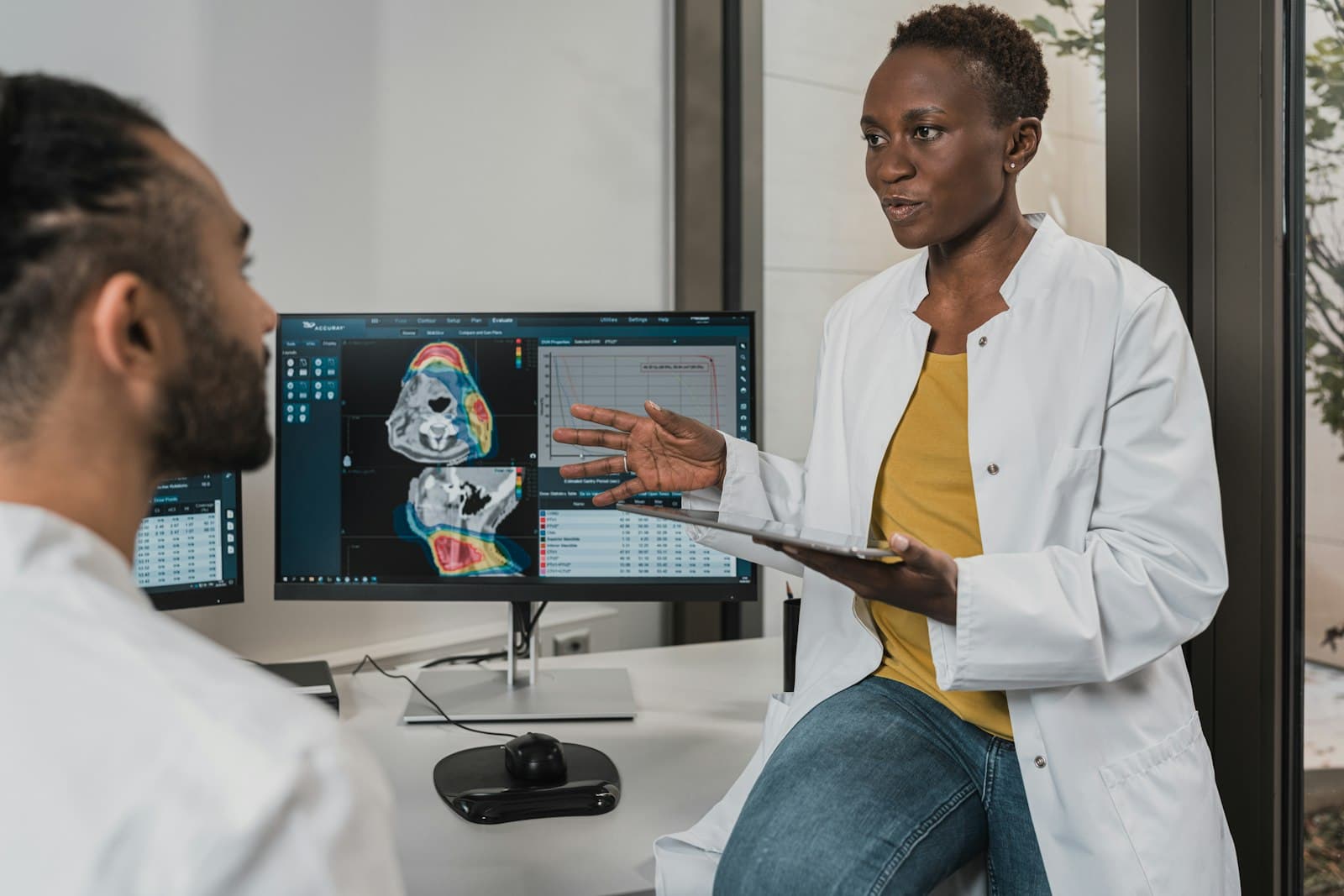 Healthcare data analyst reviewing operational dashboards in a hospital environment